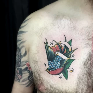 Traditionnal swallow tattoo on chest - Bird Tattoo - Black Hat Tattoo Dublin - The Black Hat Tattoo