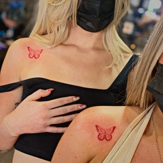 Red butterfly tattoo on shoulder - matching tattoo  - Black Hat Tattoo Dublin - The Black Hat Tattoo