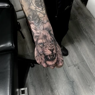 Realism lion on hand - Lion Tattoo - Black Hat Tattoo Dublin - The Black Hat Tattoo