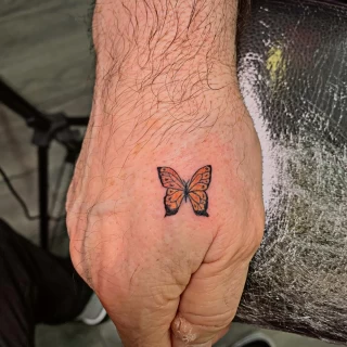 Small butterfly tattoo on hand -  - Black Hat Tattoo Dublin - The Black Hat Tattoo