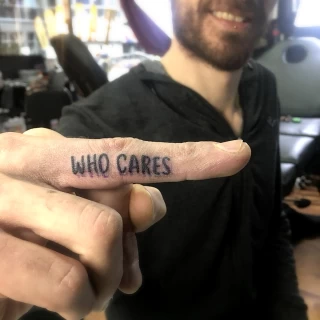 Who cares tattoo on finger - Script Quote Tattoo - Black Hat Tattoo Dublin - The Black Hat Tattoo