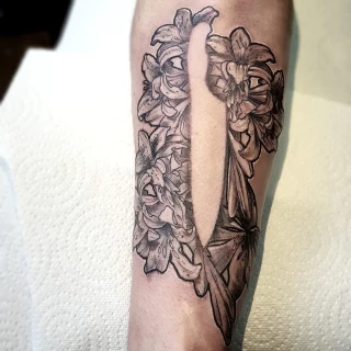knife and Lily flowers tattoo black and grey tattoo on arm - Sergy Black Hat - The Black Hat Tattoo Dublin 2019 - Artist Portfolio - The Black Hat Tattoo
