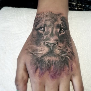 Lion Tattoo on Hand - Tattoo Artist Ireland - The Black Hat Tattoo Dublin - The Black Hat Tattoo