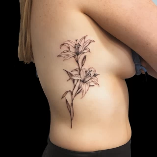 Lily flower on side -  - Flower Tattoo - Black Hat Tattoo Dublin - The Black Hat Tattoo