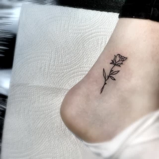 Small line work rose on feet - Rose Tattoo - Black Hat Tattoo Dublin - The Black Hat Tattoo