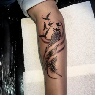 Feather and bird tattoo - Bird Tattoo - Black Hat Tattoo Dublin - The Black Hat Tattoo