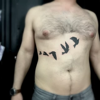 Flying bird on chest tattoo - Bird Tattoo - Black Hat Tattoo Dublin - The Black Hat Tattoo