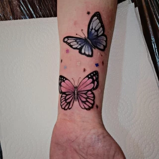 Color Butterfly Tattoo on wrist blue and pink  - Black Hat Tattoo Dublin - The Black Hat Tattoo