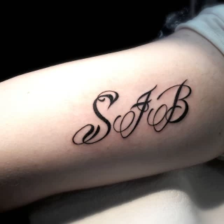 s and B letters - Script Quote Tattoo - Black Hat Tattoo Dublin - The Black Hat Tattoo